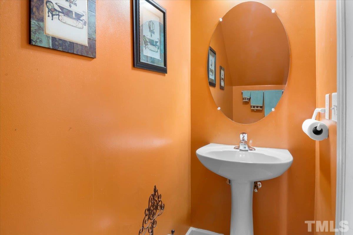 4262 Dalcross Road Raleigh, NC 27610 - Photo 14 of 27 a bathroom with a sink and a mirror