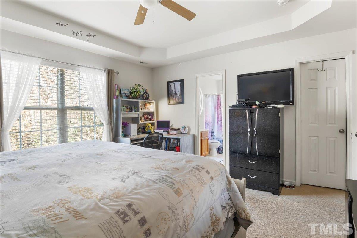4262 Dalcross Road Raleigh, NC 27610 - Photo 16 of 27 a bedroom with a bed and a flat screen tv