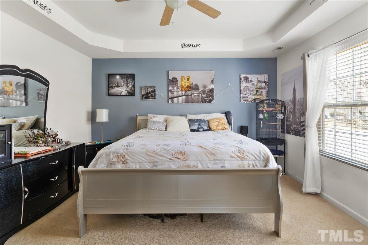 4262 Dalcross Road Raleigh, NC 27610 - Photo 17 of 27 a bedroom with a large bed and a dresser