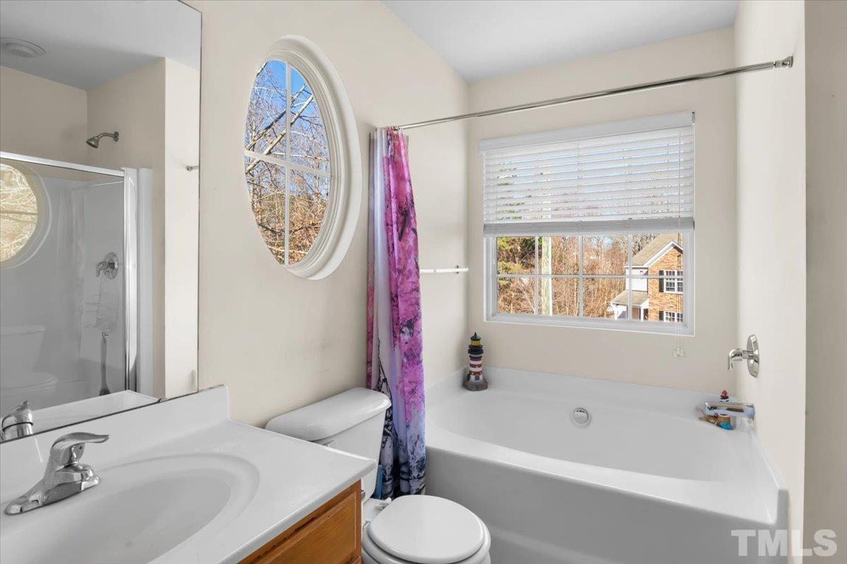 4262 Dalcross Road Raleigh, NC 27610 - Photo 18 of 27 a bathroom with a sink toilet and shower