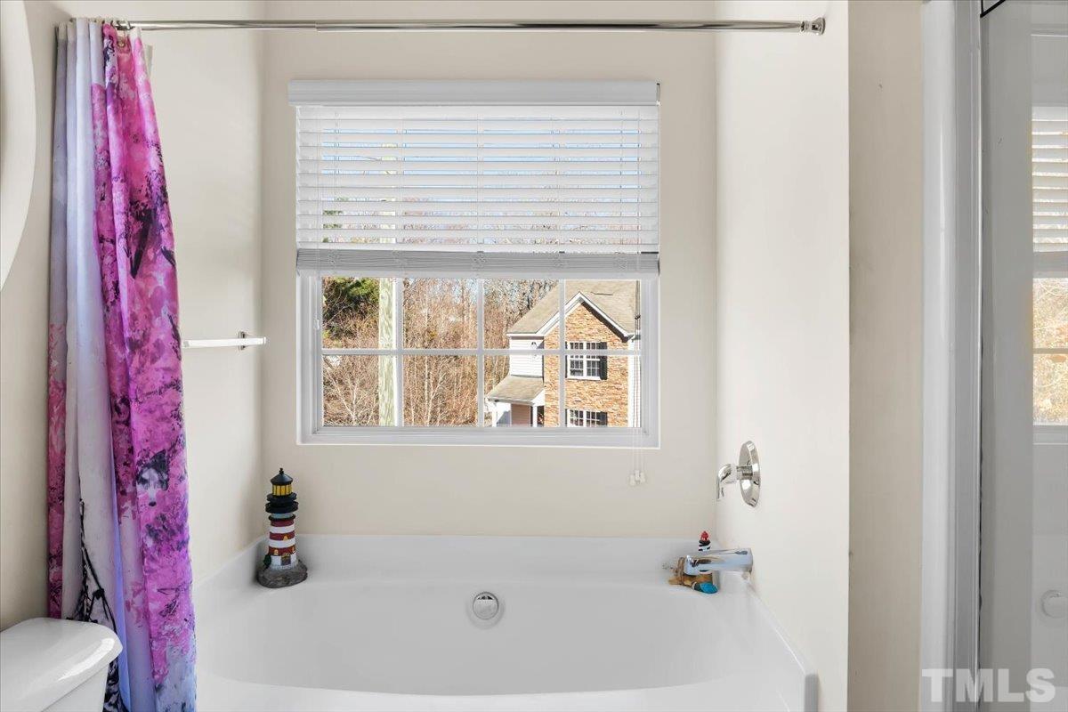 4262 Dalcross Road Raleigh, NC 27610 - Photo 19 of 27 a bathroom with a bathtub and a window