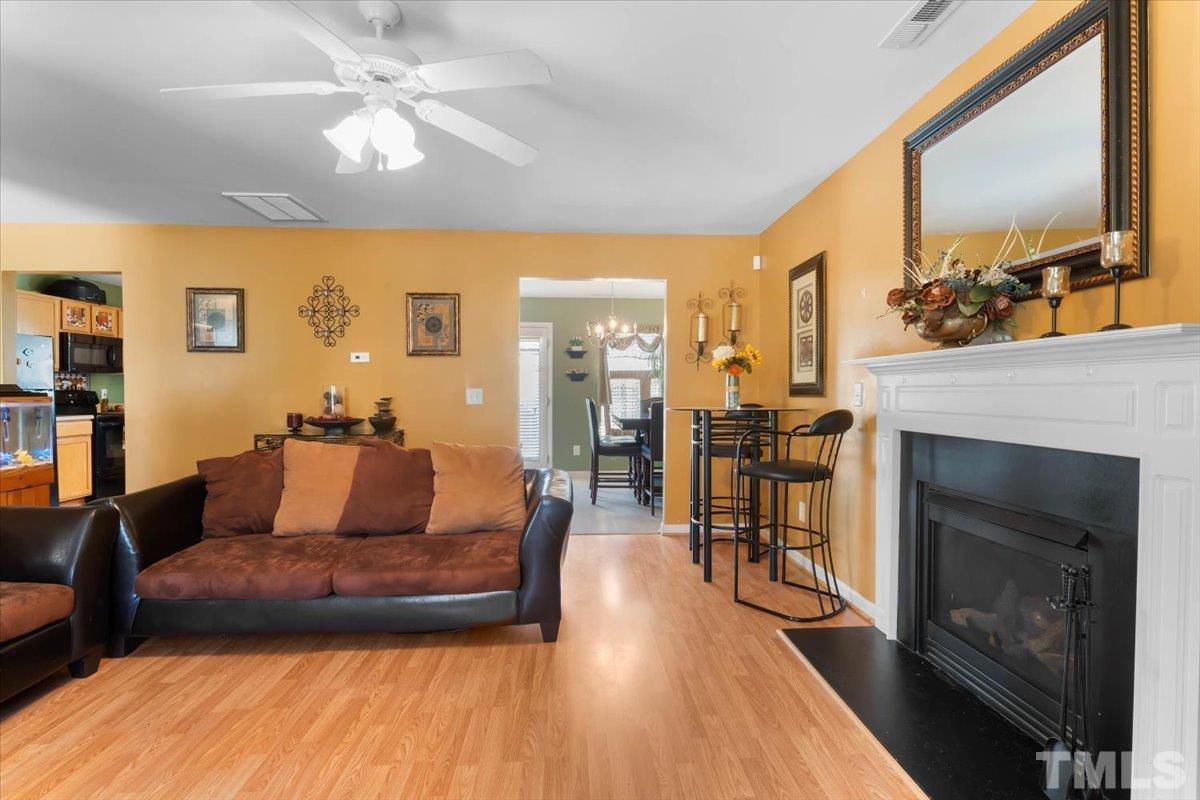 4262 Dalcross Road Raleigh, NC 27610 - Photo 7 of 27 a living room with furniture and a fireplace
