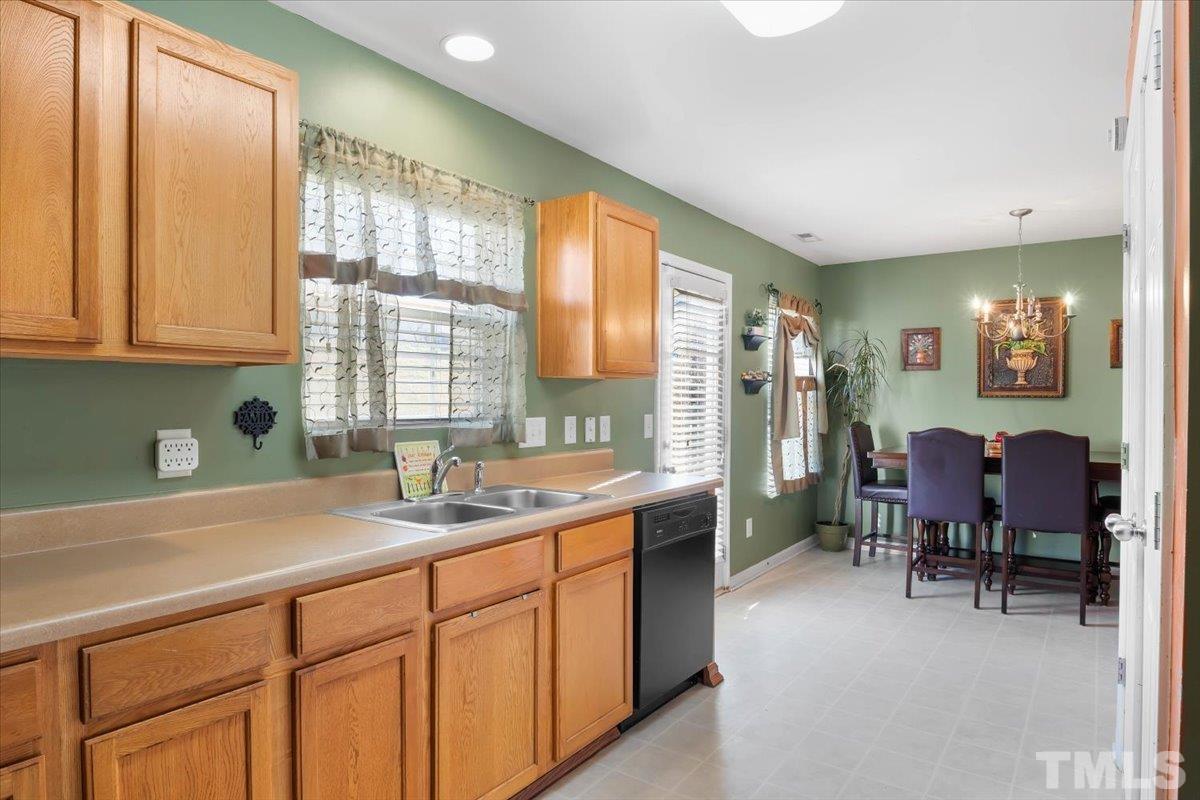 4262 Dalcross Road Raleigh, NC 27610 - Photo 10 of 27 a kitchen with a sink cabinets and dining table chair