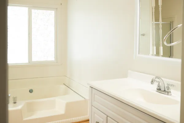 a bathroom with a bathtub and a sink