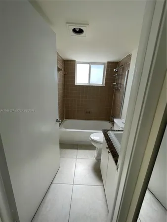 a bathroom with a tub sink and toilet