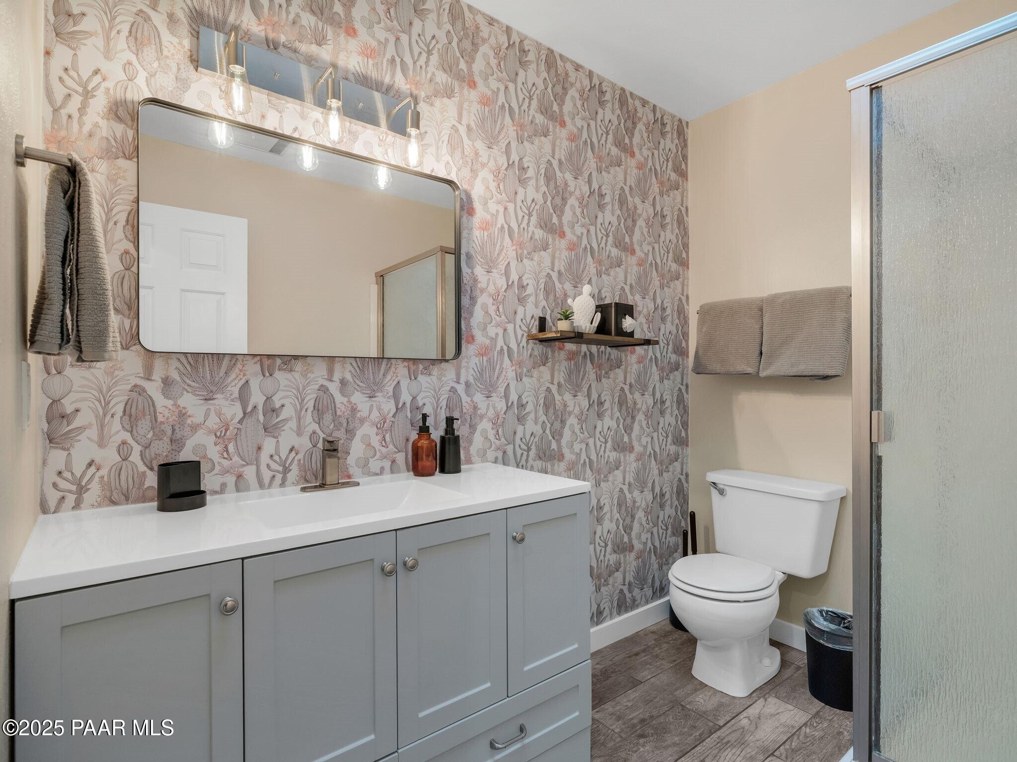 352 Rim Rock Circle, Unit 2 Prescott, AZ 86303 - Photo 19 of 25 a bathroom with a toilet sink and mirror