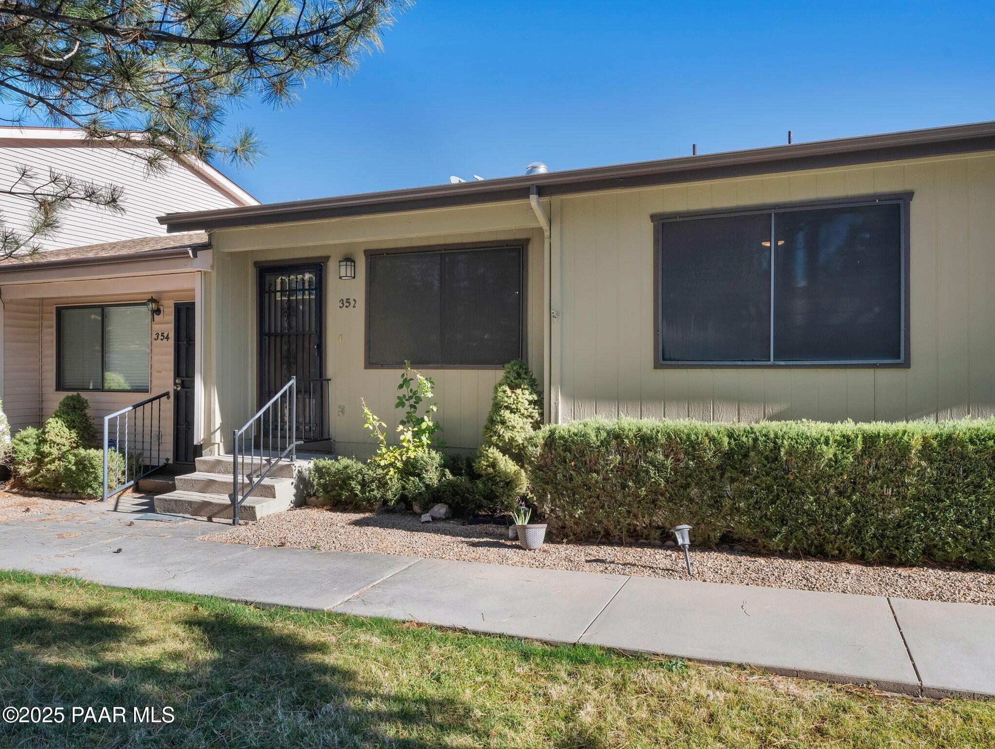 352 Rim Rock Circle, Unit 2 Prescott, AZ 86303 - Photo 2 of 25 a front view of a house with garden