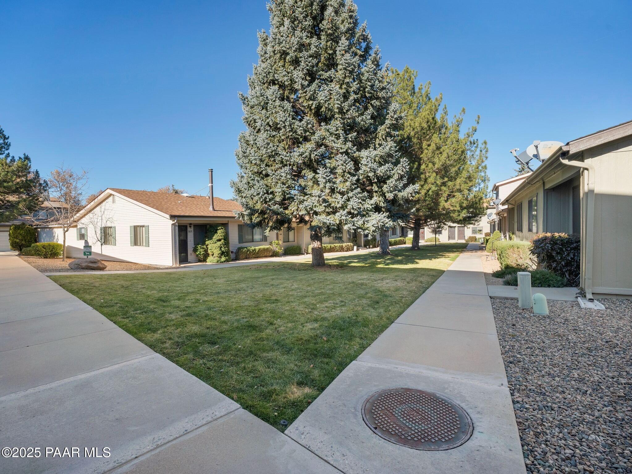 352 Rim Rock Circle, Unit 2 Prescott, AZ 86303 - Photo 22 of 25 a front view of a house with a yard
