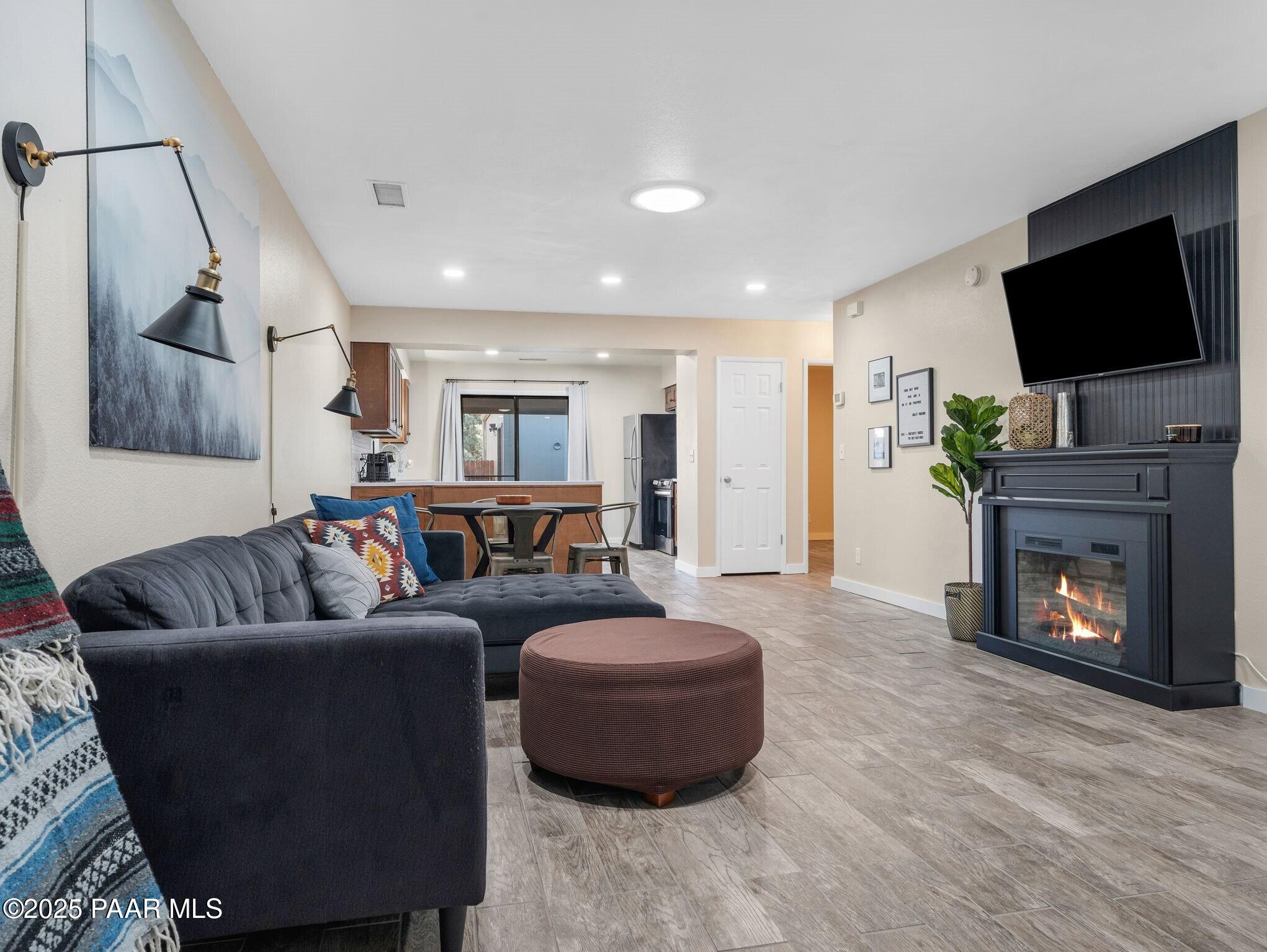 352 Rim Rock Circle, Unit 2 Prescott, AZ 86303 - Photo 5 of 25 a living room with furniture and a flat screen tv