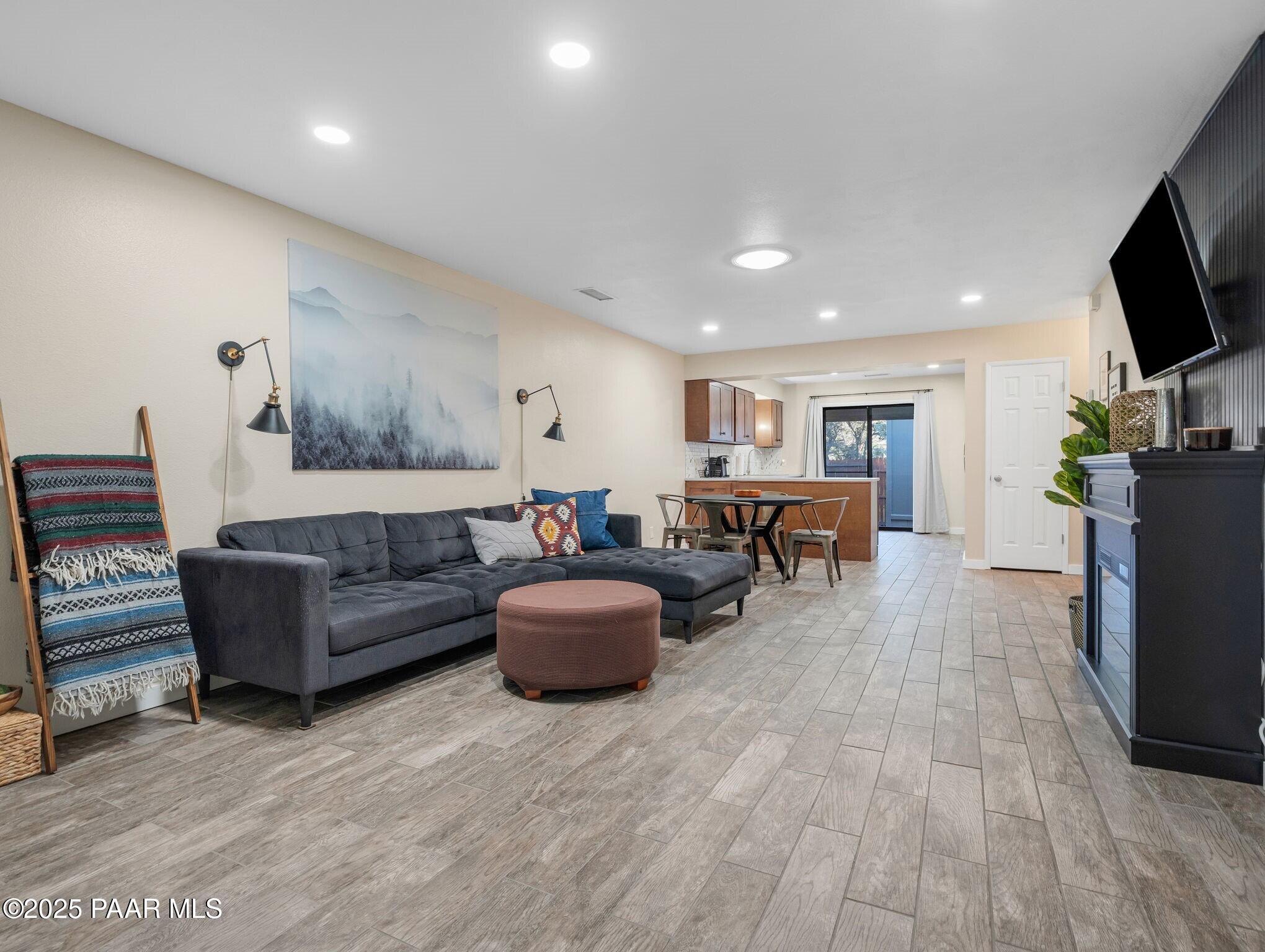 352 Rim Rock Circle, Unit 2 Prescott, AZ 86303 - Photo 6 of 25 a living room with furniture and a flat screen tv