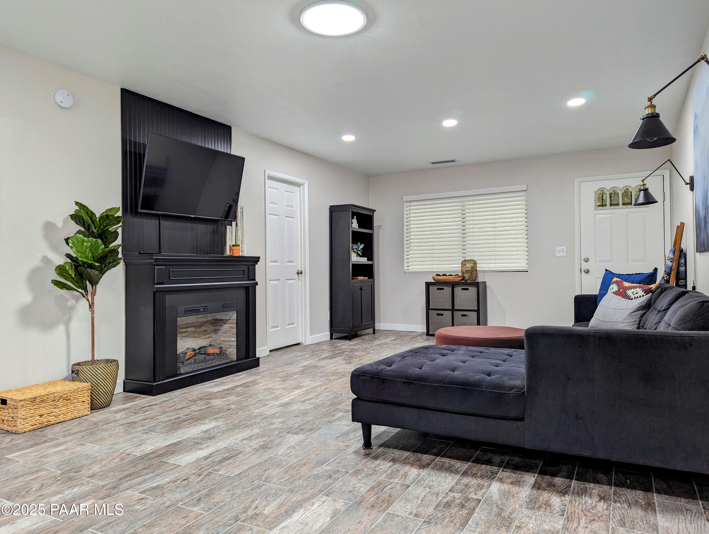 352 Rim Rock Circle, Unit 2 Prescott, AZ 86303 - Photo 7 of 25 a living room with furniture a flat screen tv and a fireplace