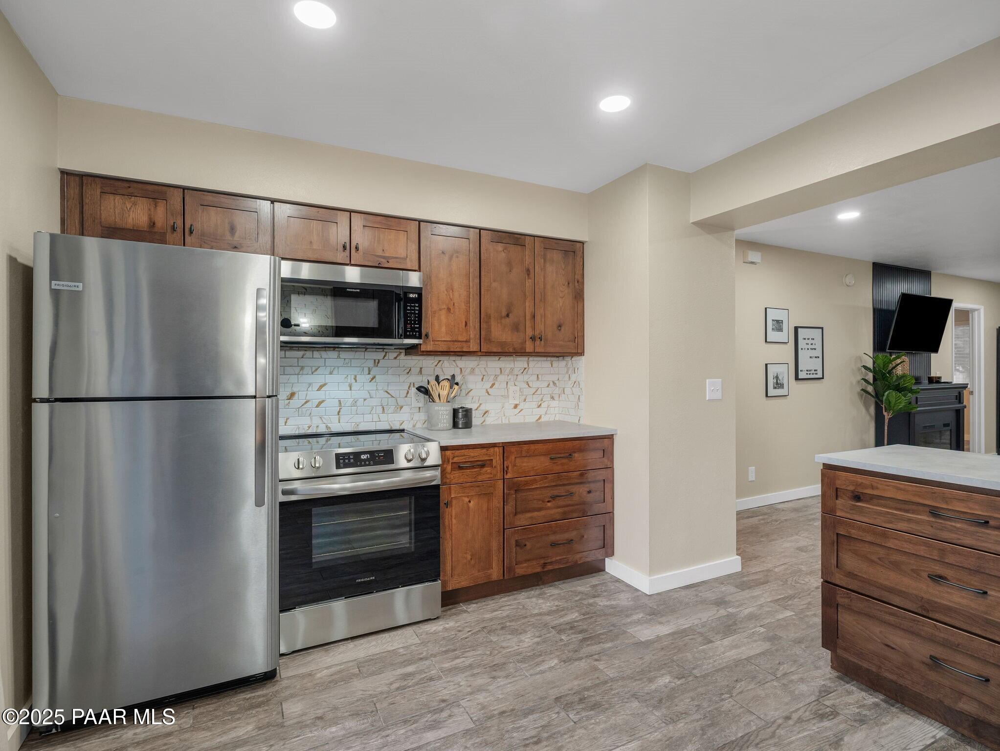 352 Rim Rock Circle, Unit 2 Prescott, AZ 86303 - Photo 9 of 25 a kitchen with stainless steel appliances granite countertop a refrigerator and a stove top oven