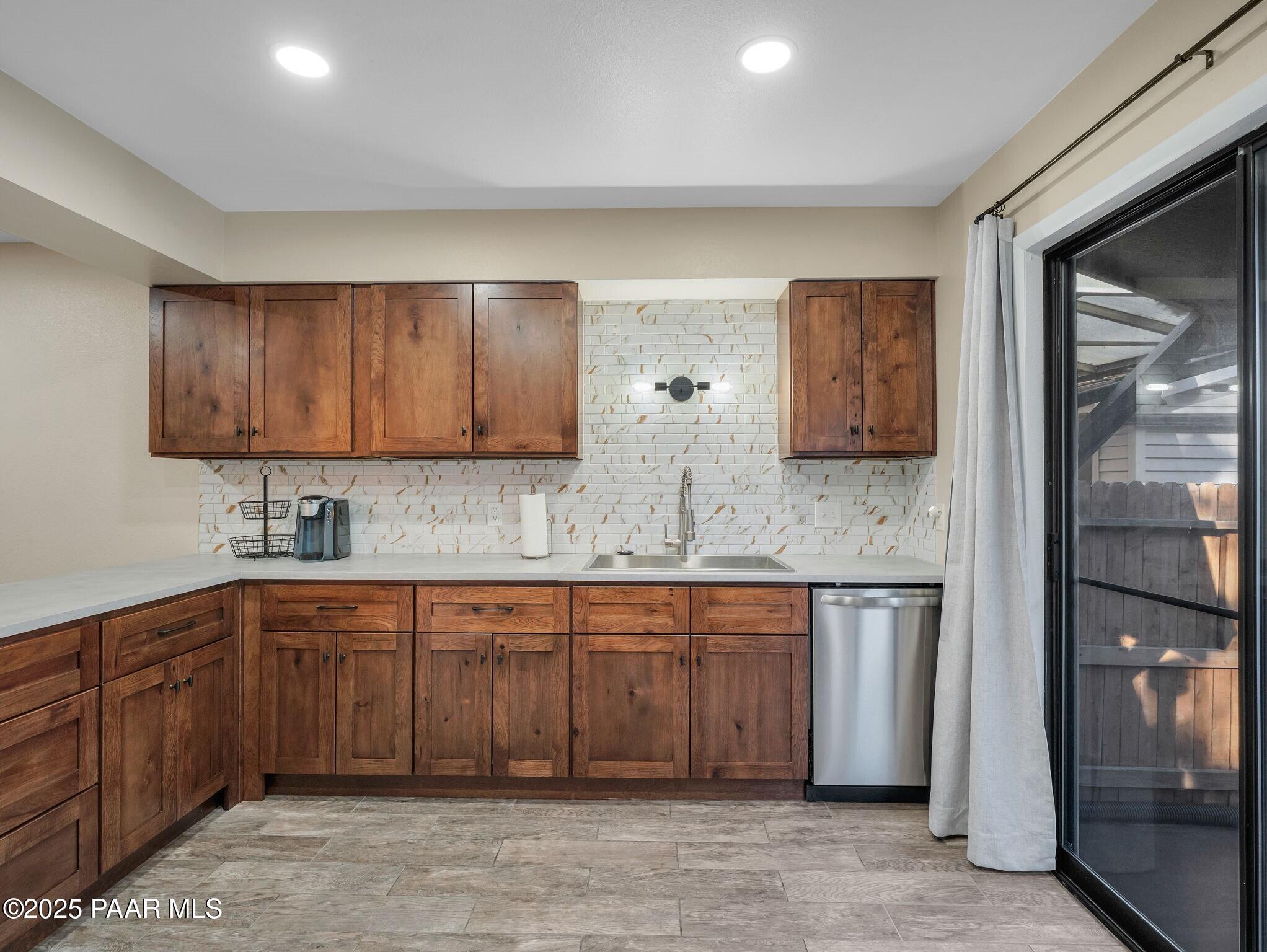 352 Rim Rock Circle, Unit 2 Prescott, AZ 86303 - Photo 10 of 25 a kitchen with stainless steel appliances granite countertop a sink and cabinets with wooden floor