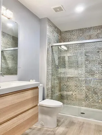 a bathroom with a toilet and a shower