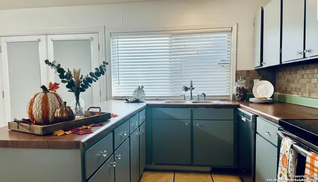 a kitchen with a sink cabinets and a window