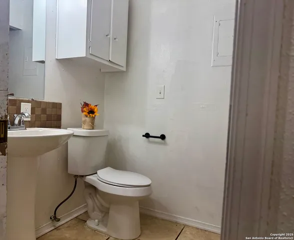 a bathroom with a toilet and a sink