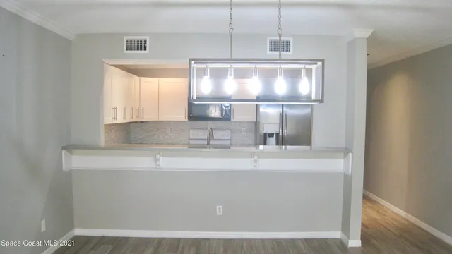a close view of kitchen countertops with wooden floor