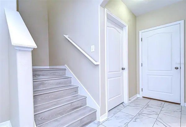 a view of entryway with wooden floor and stair