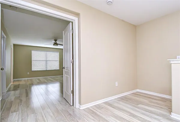 a view of empty room with wooden floor