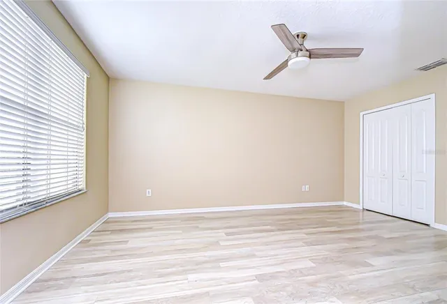 wooden floor in an empty room with a window