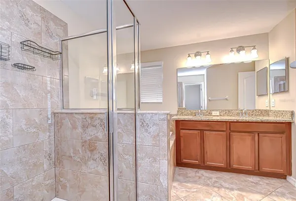 a bathroom with a granite countertop shower sink and mirror