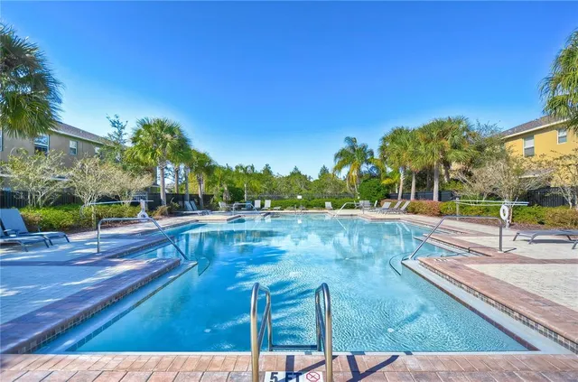 a view of a swimming pool with an outdoor seating