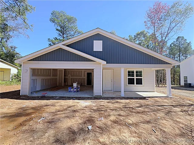 a front view of a house with yard and porch