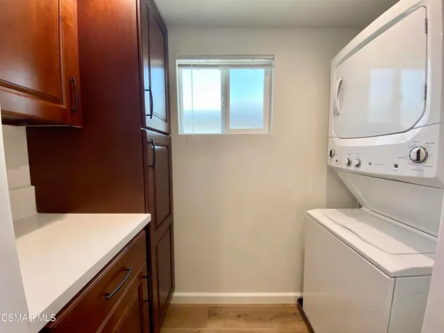 an empty room with wooden floor and door