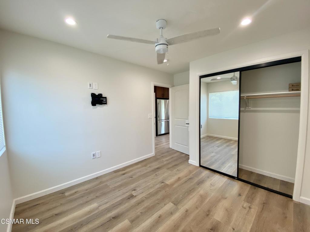 423 Saratoga Street, Unit B Fillmore, CA 93015 - Photo 13 of 20 an empty room with wooden floor and door