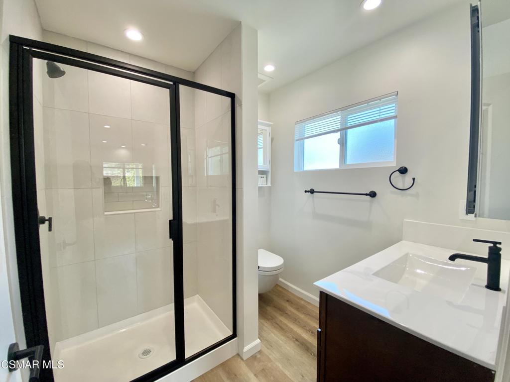 423 Saratoga Street, Unit B Fillmore, CA 93015 - Photo 15 of 20 a bathroom with a sink a mirror and a shower