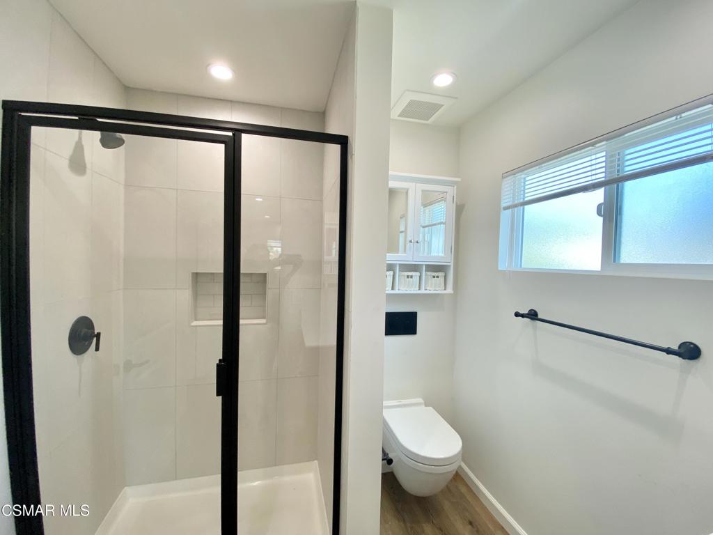 423 Saratoga Street, Unit B Fillmore, CA 93015 - Photo 16 of 20 a bathroom with a granite countertop sink toilet and shower