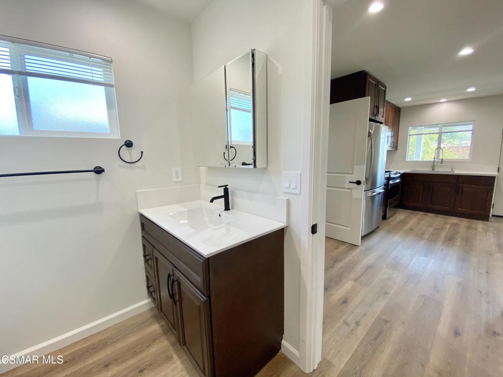 423 Saratoga Street, Unit B Fillmore, CA 93015 - Photo 17 of 20 a kitchen with a sink and a refrigerator