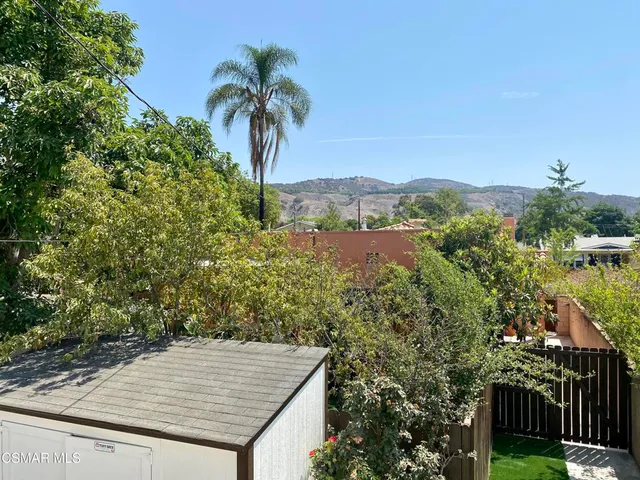 a view of a back yard from a hallway