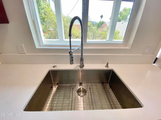a kitchen with stainless steel appliances a refrigerator and a sink