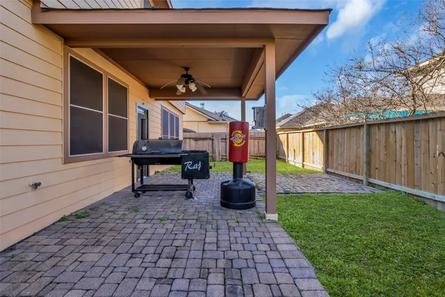 a view of a lounge chair in the back yard of the house