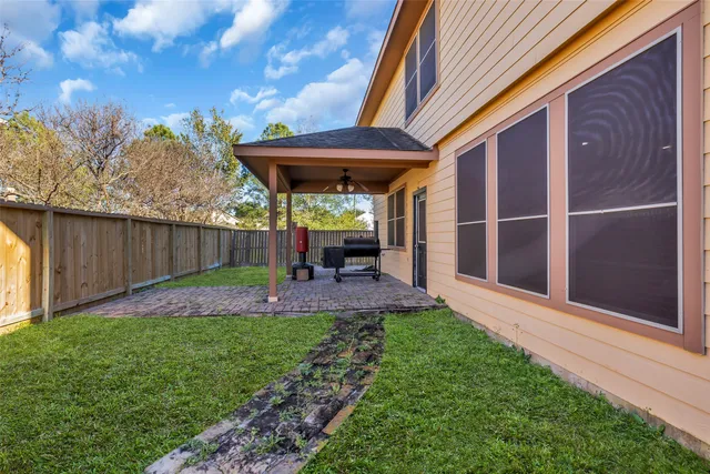 a view of a chair and table in backyard of the house