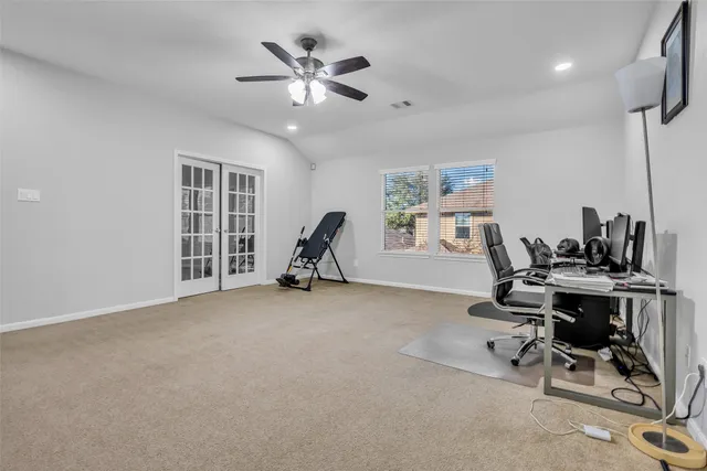 a view of a workspace with furniture and a window