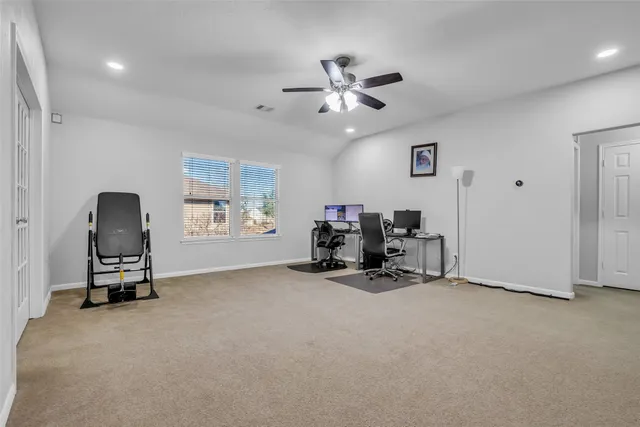 a view of a livingroom with furniture and a fan