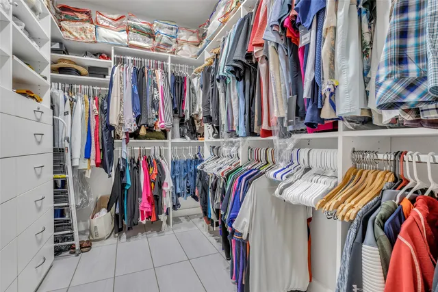 a view of walk in closet with clothes
