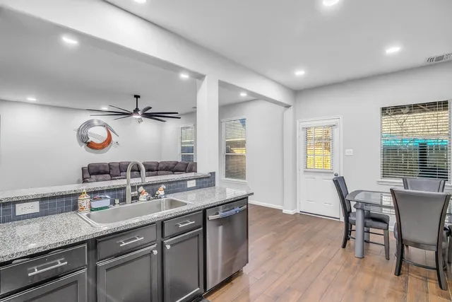 a bathroom with a granite countertop sink a mirror and a bathtub