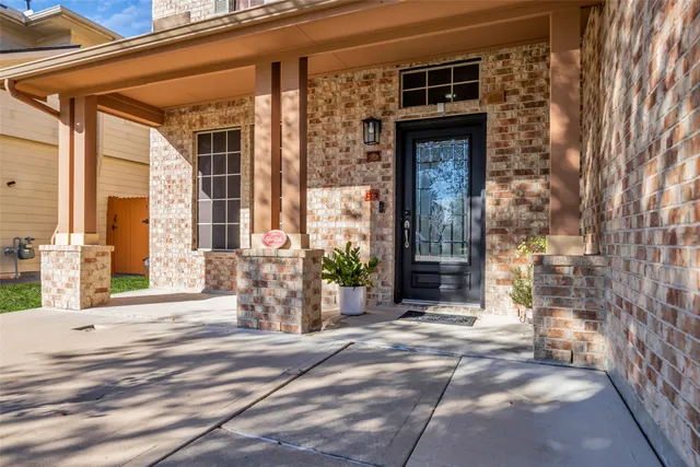 front view of a brick house with a large windows