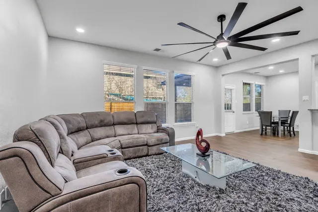 a living room with furniture and wooden floor