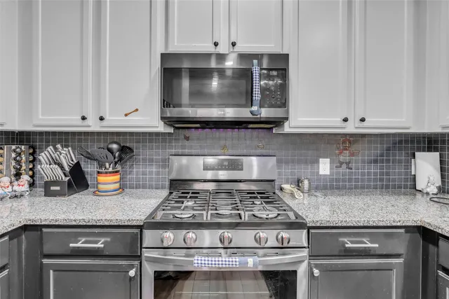 a stove top oven sitting inside of a kitchen