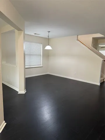 a view of a room with wooden floor and a window