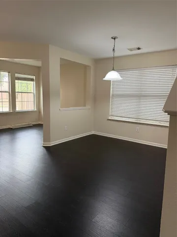 a view of a room window and wooden floor