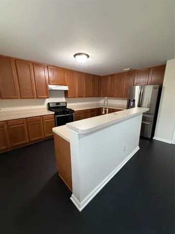 a kitchen with a sink a stove and cabinets