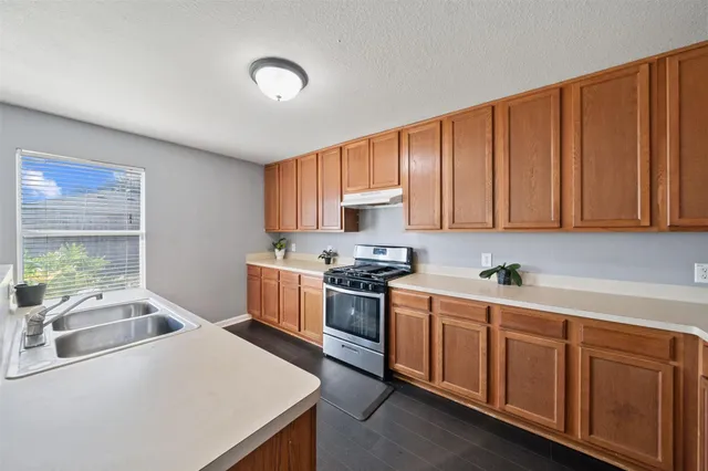 a kitchen with a stove a sink dishwasher and a microwave