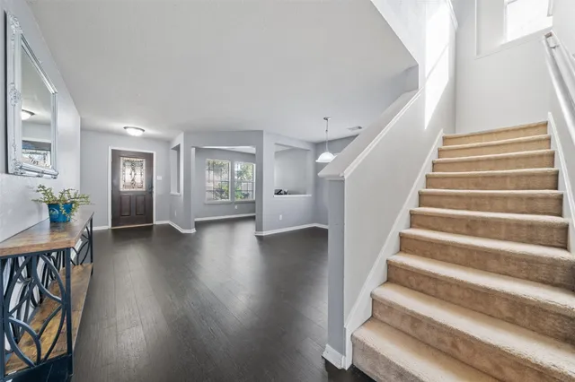a view of an entryway with wooden floor