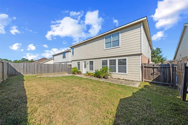 a view of a backyard with plants and a patio
