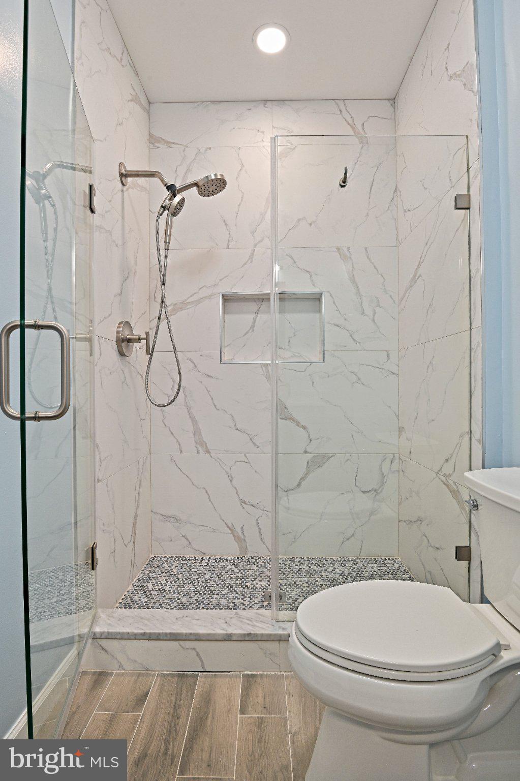 1519 North Point Drive, Unit 202 Reston, VA 20194 - Photo 22 of 49 Sleek modern shower with elegant tiles.